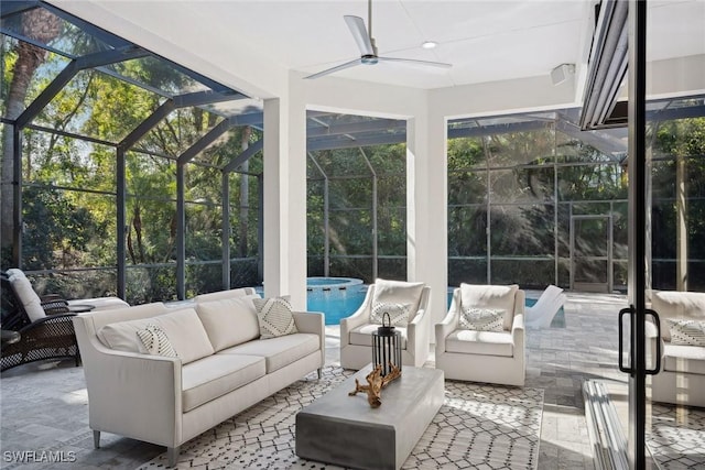 sunroom / solarium with ceiling fan and a swimming pool