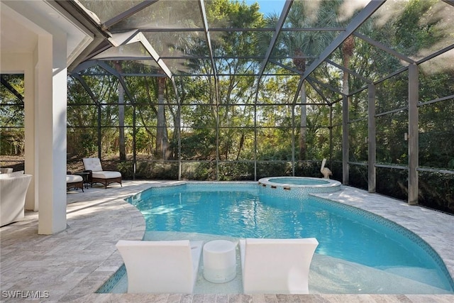 view of swimming pool featuring an in ground hot tub, a lanai, and a patio area