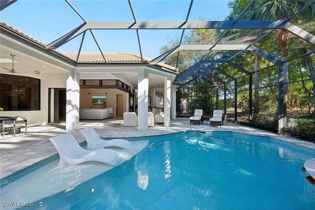 view of swimming pool featuring a lanai, ceiling fan, and a patio area