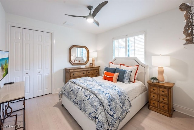 bedroom with ceiling fan, a closet, and light wood-type flooring