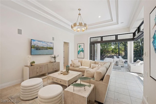 living room with a tray ceiling, an inviting chandelier, ornamental molding, and light tile patterned flooring