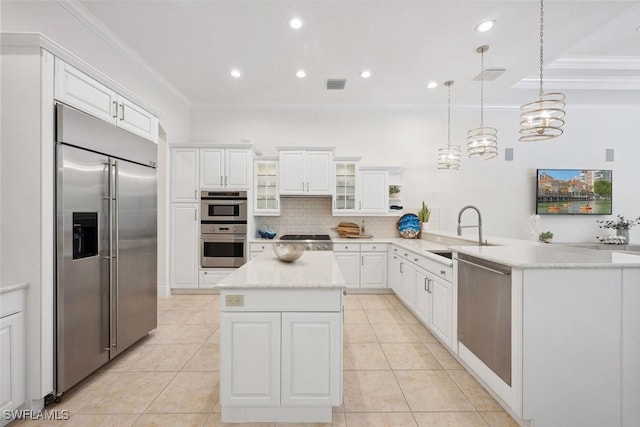 kitchen featuring pendant lighting, white cabinets, sink, appliances with stainless steel finishes, and kitchen peninsula