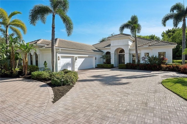 mediterranean / spanish-style house with a garage