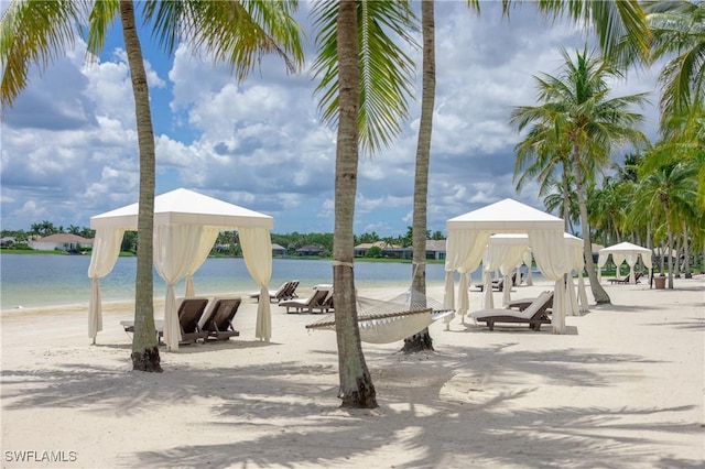 surrounding community featuring a gazebo, a water view, and a view of the beach