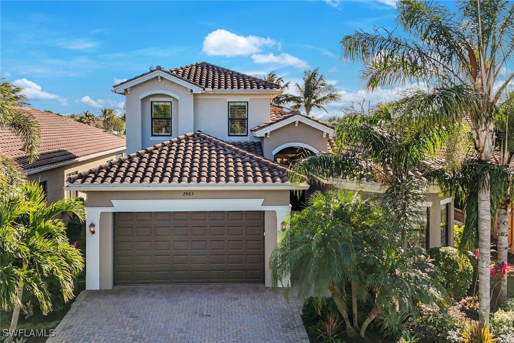 mediterranean / spanish house featuring a garage