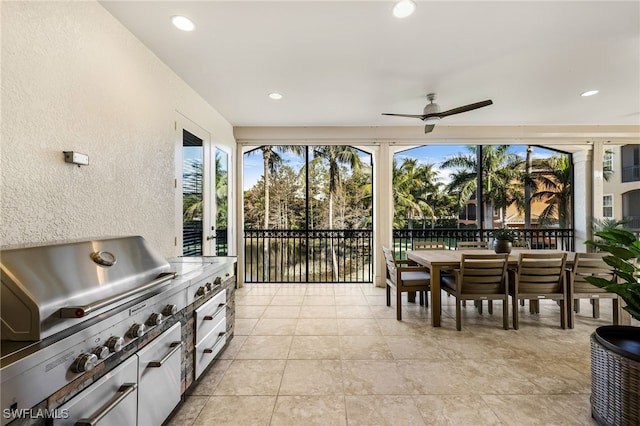 sunroom featuring ceiling fan