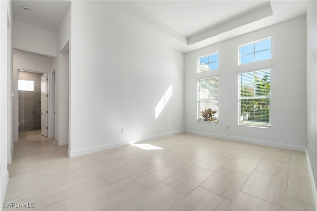 unfurnished room with a raised ceiling