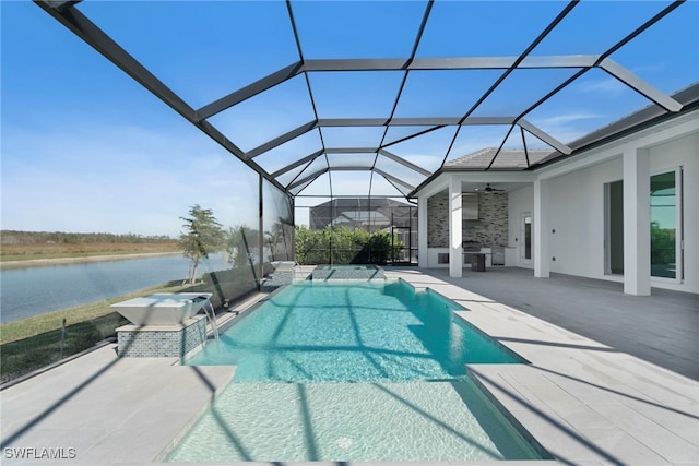 view of swimming pool featuring a patio area, ceiling fan, a water view, and glass enclosure