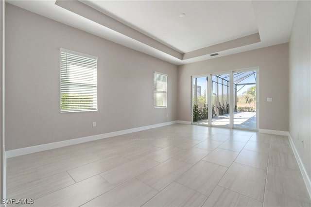 empty room featuring a tray ceiling