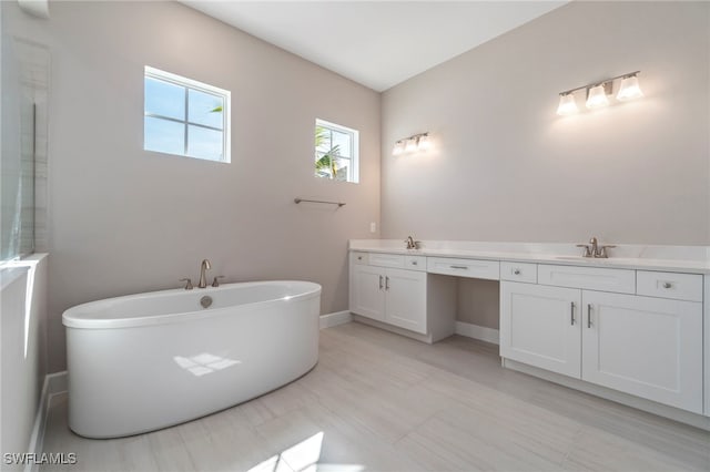 bathroom featuring vanity and a tub