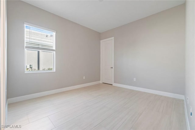 unfurnished room featuring baseboards