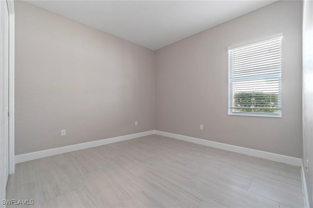 empty room featuring baseboards