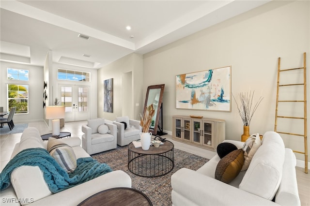 living room featuring french doors, recessed lighting, a raised ceiling, visible vents, and baseboards