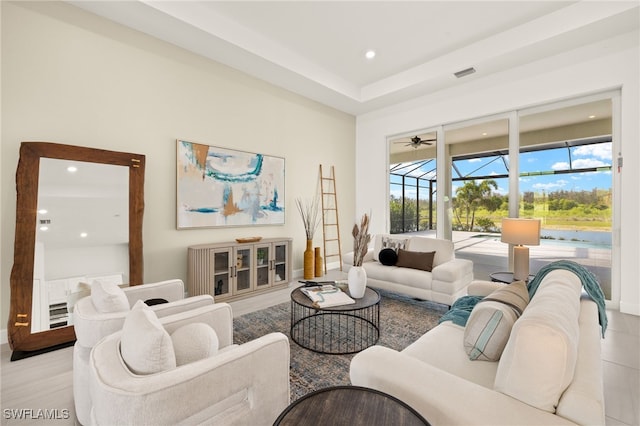 living room featuring visible vents, baseboards, a sunroom, and recessed lighting