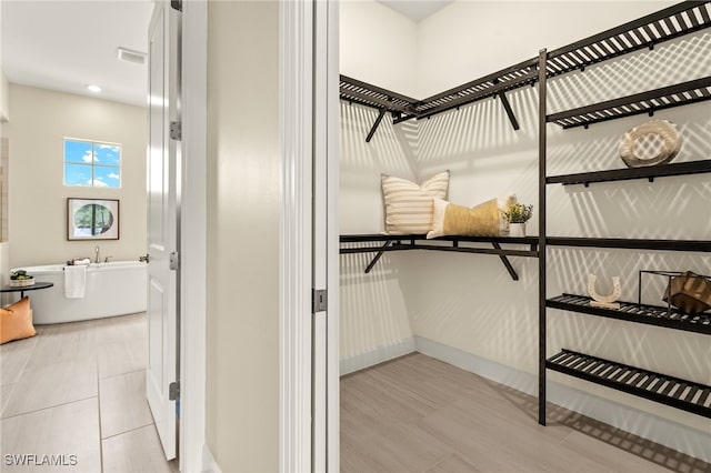 spacious closet featuring tile patterned flooring and visible vents