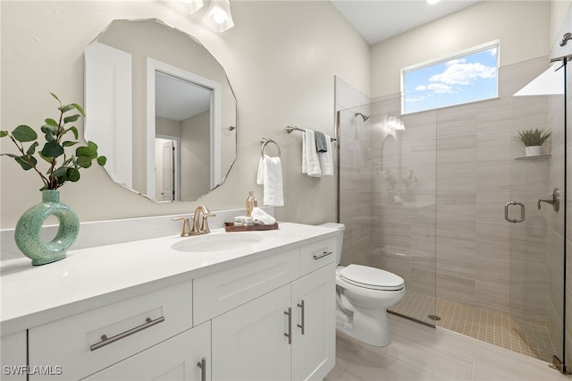 bathroom featuring toilet, tile patterned flooring, a shower stall, and vanity