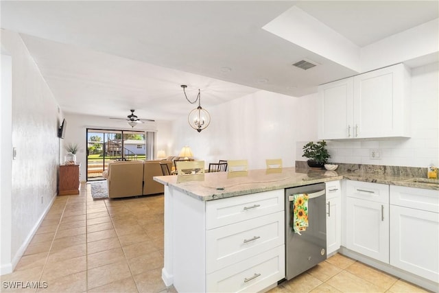 kitchen with kitchen peninsula, white cabinets, stainless steel dishwasher, and ceiling fan with notable chandelier