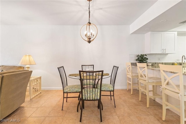 dining area featuring a chandelier and light tile patterned floors