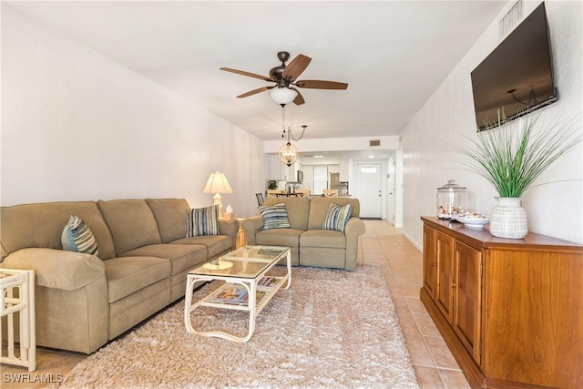 living room featuring ceiling fan and light tile patterned flooring