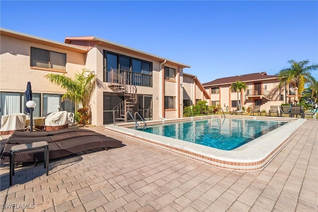 view of swimming pool with a patio area