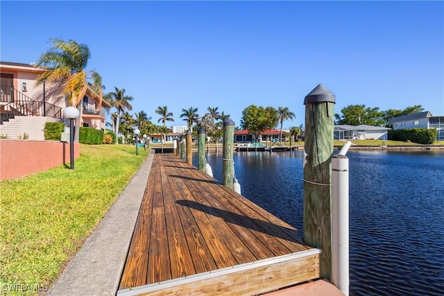 dock area featuring a yard and a water view