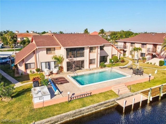 back of property featuring a patio area and a water view