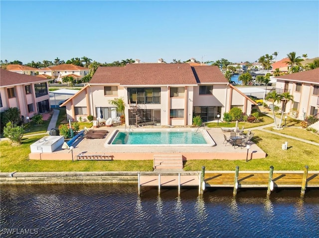 back of house with a patio area and a water view