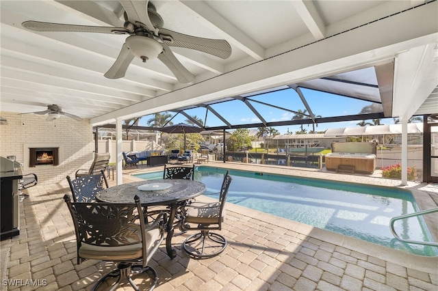 view of swimming pool featuring glass enclosure, a patio area, and a hot tub