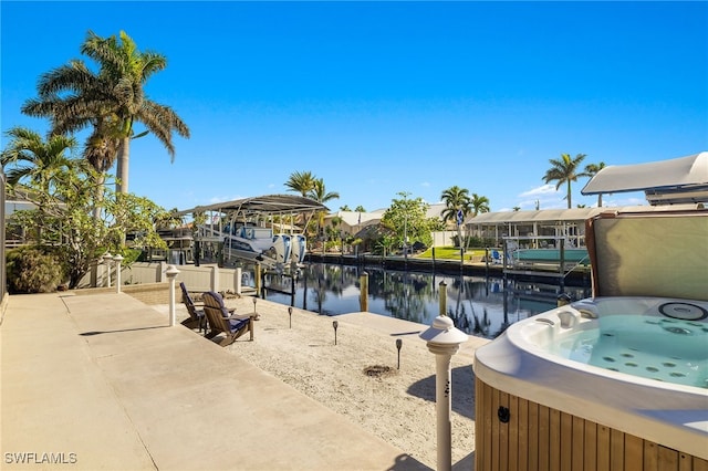 dock area featuring a water view and a hot tub