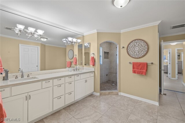 bathroom featuring tile patterned floors, a tile shower, vanity, crown molding, and a chandelier