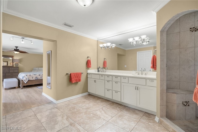 bathroom featuring tile patterned flooring, vanity, ceiling fan, and crown molding