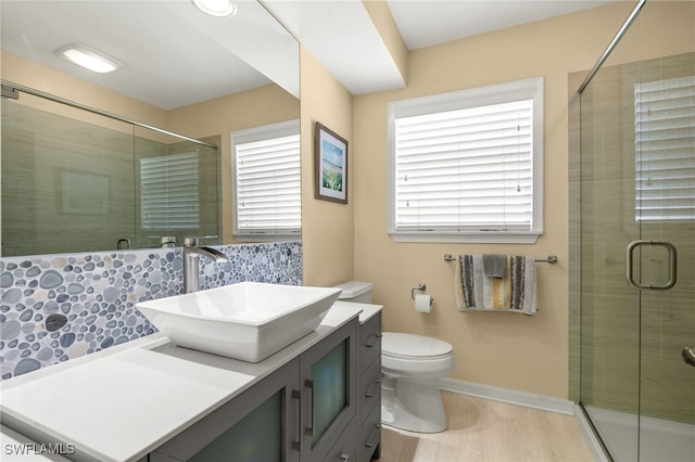 bathroom with vanity, hardwood / wood-style flooring, toilet, and an enclosed shower