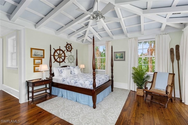 bedroom featuring ceiling fan, beamed ceiling, and dark wood-type flooring