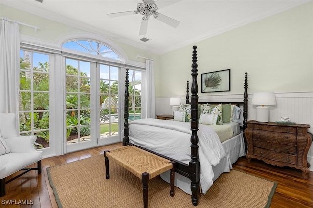 bedroom featuring ceiling fan, dark hardwood / wood-style floors, access to exterior, and ornamental molding