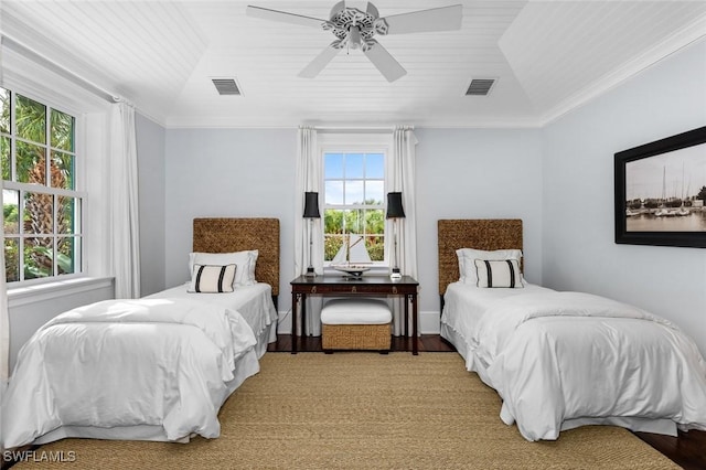 bedroom with hardwood / wood-style floors, multiple windows, and ceiling fan