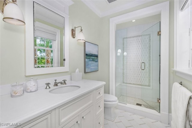 bathroom featuring crown molding, a shower with door, vanity, and toilet