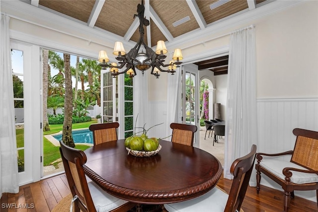 dining room with a wealth of natural light, hardwood / wood-style floors, wood ceiling, and a notable chandelier