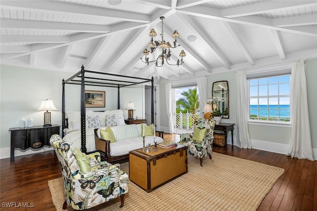 bedroom with hardwood / wood-style flooring, a notable chandelier, a water view, and multiple windows