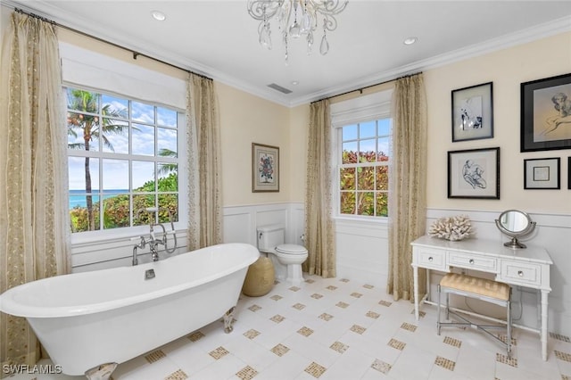 bathroom with toilet, crown molding, a wealth of natural light, and a tub