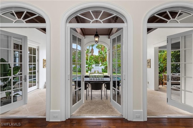 entryway with french doors and dark hardwood / wood-style flooring