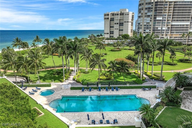 view of swimming pool featuring a water view