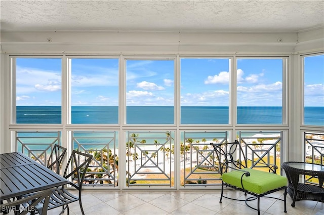 unfurnished sunroom with a water view and a healthy amount of sunlight