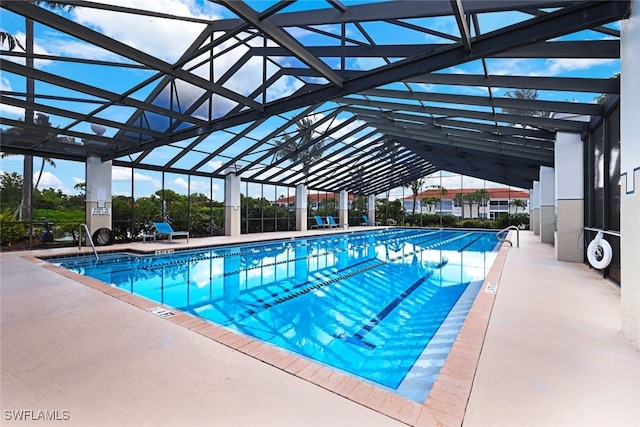 view of swimming pool with a lanai and a patio