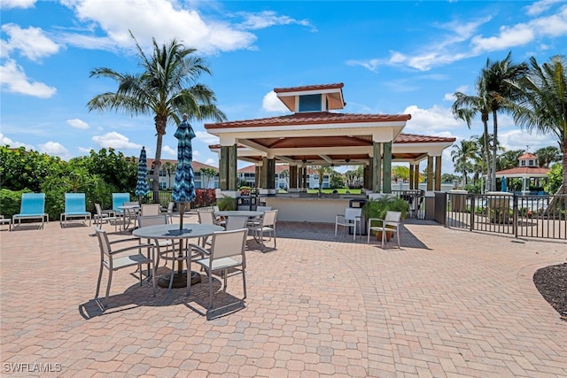 view of patio featuring a gazebo, a water view, and an outdoor bar