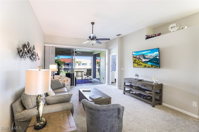 carpeted living room with ceiling fan