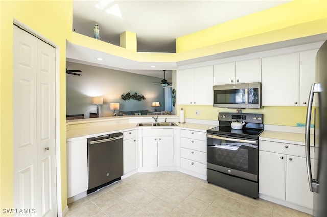 kitchen with stainless steel appliances, white cabinetry, ceiling fan, and sink