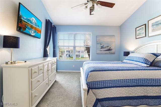 carpeted bedroom with vaulted ceiling and ceiling fan