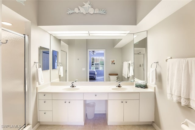 bathroom featuring tile patterned flooring, vanity, and walk in shower