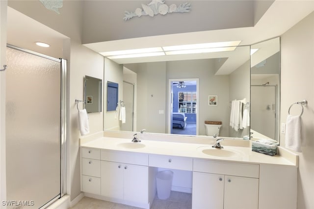 bathroom with tile patterned flooring, vanity, and walk in shower