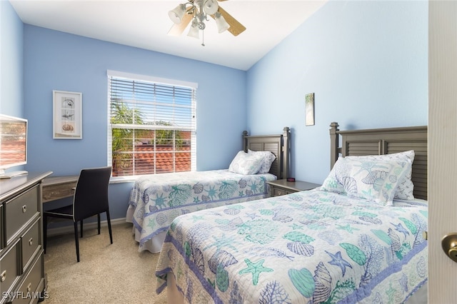 carpeted bedroom with vaulted ceiling and ceiling fan